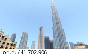 Bottom view of panorama Burj Khalifa at blue sky in tourist district of Dubai city, UAE (2023 год). Стоковое видео, видеограф Aleksandr Golubev / Фотобанк Лори