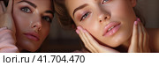 Two young cute girls examine their face after a massage in the mirror. The concept of youth and beauty. Generated by AI. Стоковое AI-изображение, AI-художник Ярославский Максим / Фотобанк Лори