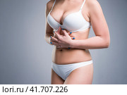 Woman in white underwear with abdominal pain. Стоковое фото, фотограф Станислав Тарко / Фотобанк Лори