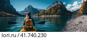 A girl on a yellow canoe is sailing on a mountain lake in calm weather. T Generated by AI. Стоковое AI-изображение, AI-художник Ярославский Максим / Фотобанк Лори