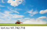 Watering, treating fields with crops with Pesticides and Herbicides on a tractor. Agricultural industry. Стоковое AI-изображение, AI-художник Ирина Ручушкина / Фотобанк Лори