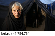 Portrait of Refugees on middle east looking at camera. Homeless people, unhappy and frightened, shawl camps,  Generative AI. Стоковое AI-изображение, AI-художник Анна Кривицкая / Фотобанк Лори