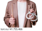 Woman teacher holding handcuffs in her hands on a isolated on a white background, close-up. Стоковое фото, фотограф Андрей Журавлев / Фотобанк Лори