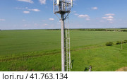 Cellular tower. Equipment for relaying cellular and mobile signal. Fly around up and down. Стоковое фото, фотограф Леонид Еремейчук / Фотобанк Лори