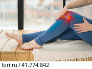 Knee pain, woman suffering from osteoarthritis at home. Стоковое фото, фотограф Станислав Тарко / Фотобанк Лори