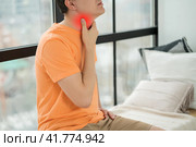 Sore throat and cough, man with pain in neck at home. Стоковое фото, фотограф Станислав Тарко / Фотобанк Лори