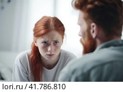 Close up man in front and upset girl with freckles behind sit at sofa to talk at home, offended red-haired teen daughter and middle aged father argument, adolescence, two generation conflict concept. Стоковая иллюстрация, иллюстратор Оксана Гильман / Фотобанк Лори