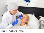 Cosmetologist doing botulotoxin injections for young woman. Стоковое фото, фотограф Яков Филимонов / Фотобанк Лори