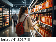 A woman who focuses on conscious consumption thoughtfully navigates the aisles of the supermarket, prioritizing nutritional value. Generated by AI. Стоковое AI-изображение, AI-художник Ярославский Максим / Фотобанк Лори