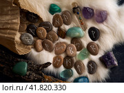handmade stone runes on white fur. Стоковое фото, фотограф Boris Vasilenko / Фотобанк Лори