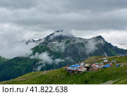 Houses on a green slope and cable car. Dombay, Karachay-Cherkessia, Russia. Стоковое фото, фотограф Владимир Глинский / Фотобанк Лори
