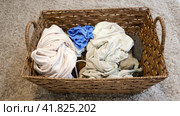 Filling the basket with adult and baby clothing, stop motion. Sorting male and female clothes after washing, time lapse. Стоковое видео, видеограф Андрей Журавлев / Фотобанк Лори