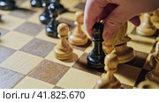Capturing a white knight by a black bishop in a chess game. Man hand with a chess piece in a board game. Стоковое видео, видеограф Андрей Журавлев / Фотобанк Лори