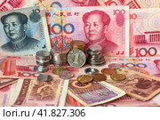 Close-up view of Yuan coins in stacks and Yuan paper money. Chinese economy, finance and international relations. Currency background. World trade, inflation, investment, business and lending. Стоковое фото, фотограф Виктория Катьянова / Фотобанк Лори