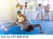Boy twists the arm of an coach during self-defense training in gym. Стоковое фото, фотограф Яков Филимонов / Фотобанк Лори
