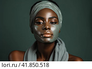 A young and very beautiful African girl with a green cosmetology mask on her face looks away with a smile and blissfully smiles. Стоковое AI-изображение, AI-художник Ярославский Максим / Фотобанк Лори