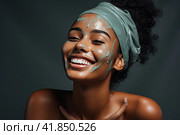 A young and very beautiful African girl with a green cosmetology mask on her face looks away with a smile and blissfully smiles. Стоковое AI-изображение, AI-художник Ярославский Максим / Фотобанк Лори