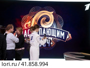 Посетители выставки фотографируются на стенде Первого канала на фоне поздравления "С наступающим 2024" на выставке-форуме "Россия" на ВДНХ в городе Москве, Россия (2023 год). Редакционное фото, фотограф Николай Винокуров / Фотобанк Лори