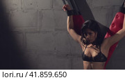 Slim woman in underwear locked with cross in bdsm studio. Стоковое видео, видеограф Гурьянов Андрей / Фотобанк Лори