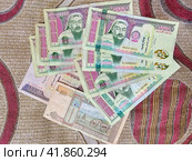 Mongolian paper money is fanned out on the carpet. Стоковое фото, фотограф Саблин Станислав / Фотобанк Лори
