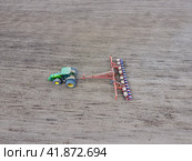 Sowing of corn. Tractor with a seeder on the field. Using a seeder for planting corn. Стоковое фото, фотограф Леонид Еремейчук / Фотобанк Лори