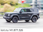 Tank 300 car is driving in the cityscape. Front side view of black chinese SUV in motion. Редакционное фото, фотограф Константин Григорьев / Фотобанк Лори