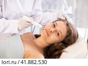 Young girl undergoing radiofrequency skin tightening procedure at cosmetology clinic. Стоковое фото, фотограф Яков Филимонов / Фотобанк Лори