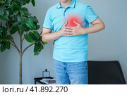 Heart attack, man with chest pain suffering at home, myocardial infarction. Стоковое фото, фотограф Станислав Тарко / Фотобанк Лори