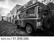TEGUISE (village), LANZAROTE, CANARY ISLANDS - OCTOBER 26, 2023: Short-wheelbase Land Rover series III on the streets of the historic center of the village Teguise. Black and white. Редакционное фото, фотограф Sergey Kohl / Фотобанк Лори