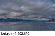 A calm seascape. Islets in the Beagle Channel. Ripples on the ocean surface. Mountains against a background of blue sky and clouds. Argentina. Tierra del Fuego Archipelago (2023 год). Стоковое фото, фотограф Вера Ивановна Кубарева / Фотобанк Лори
