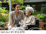 A young Asian girl is talking to her mother in a wheelchair. The concept of caring for the older generation. Стоковое AI-изображение, AI-художник Ярославский Максим / Фотобанк Лори