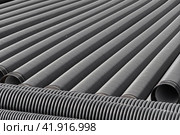Черные пластиковые трубы для водоснабжения или канализации. Black plastic pipes for water supply or sewerage prepared for installation or repair of the water supply system. Стоковое фото, фотограф Татьяна Д / Фотобанк Лори