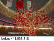 Istanbul, Turkey 12.31.23: international airport Istanbul Havalimani IST. New Year and Christmas decorations, garlands, small architectural forms. Multi-colored light bulbs create festive atmosphere. Редакционное фото, фотограф Юлия Петровская / Фотобанк Лори