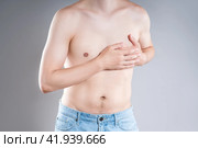 Heart attack, man with chest pain on a gray background, myocardial infarction. Стоковое фото, фотограф Станислав Тарко / Фотобанк Лори
