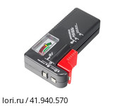 Измеритель заряда батареек на белом фоне. Meter battery tester batteries batteriemessger. Стоковое фото, фотограф Татьяна Д / Фотобанк Лори