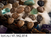 handmade stone runes on white fur. Стоковое фото, фотограф Boris Vasilenko / Фотобанк Лори