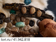 handmade stone runes on white fur. Стоковое фото, фотограф Boris Vasilenko / Фотобанк Лори