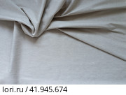 Stylish natural linen fabric. Light gray textile background. Base for sewing breathable, light, fashionable clothes. Empty space for text. Flat lay, close-up, top view, copy space, mock up. Стоковое фото, фотограф Виктория Катьянова / Фотобанк Лори
