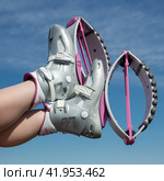 Crop close-up view of woman crossed legs up in air shod in pink Kangoo Jumps boots during outdoor aerobic fitness workout (2022 год). Редакционное фото, фотограф А. А. Пирагис / Фотобанк Лори