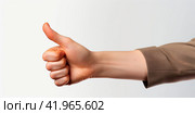 A man's hand on a white background, with a short sleeve suit showing a thumbs up. The concept of luck and success. Isolated. Стоковое AI-изображение, AI-художник Ярославский Максим / Фотобанк Лори