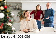 Domestic quarrel during Christmas celebration. Man does not want to talk because of disagreements with his father and wife. Стоковое фото, фотограф Яков Филимонов / Фотобанк Лори