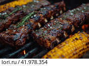 Gaucho cooking the meat on the fire, making the barbecue on the coals, Photos and menus of cafes and restaurants, Magazines. Стоковое AI-изображение, AI-художник Ирина Ручушкина / Фотобанк Лори
