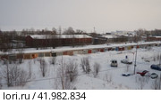 Lake Onega, Petrozavodsk, Karelia 01.12.24 Industrial landscape. Frosty winter. Gray cloud. Real time. View of the ice-frozen lake from Klyuchevaya. Snowfall blizzard. Parking near garage cooperative (2017 год). Редакционное видео, видеограф Юлия Петровская / Фотобанк Лори