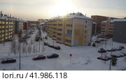 Petrozavodsk Karelia Russia, 01.12.24 Frosty winter cityscape. Taiga winter low sun in haze. Multicolored five-story houses. Extremely north. Large-panel housing construction. Parking lot frozen cars (2017 год). Редакционное видео, видеограф Юлия Петровская / Фотобанк Лори