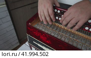 The man checks the compression of the butt button. It presses the valves to the body and spreads the fur. Bayan repair and maintenance. Стоковое видео, видеограф Vadzim Yakubovich / Фотобанк Лори