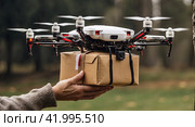 A postal drone carries a box with parcel, hands over the package. Modern technologies, delivery of goods. AI generated. Стоковое AI-изображение, AI-художник Ольга Симонова / Фотобанк Лори