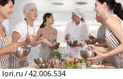 Elderly woman holds glass of cool white wine in hands and converse with participant at culinary courses. Стоковое видео, видеограф Яков Филимонов / Фотобанк Лори