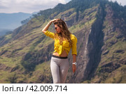 Portrait of perfect lady in yellow enjoy at tropical journey, posing looking away. Lovely adult woman at landscape Sri Lanka Adam's peak mountain, landmark nature, Ella, Sri Lanka. Copy ad text space (2022 год). Стоковое фото, фотограф Aleksandr Golubev / Фотобанк Лори