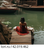 a woman in a red skirt is sitting in a boat with an airplane on the dock. Стоковое AI-изображение, AI-художник Юлия Гапеенко / Фотобанк Лори