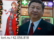 Ростовая картонная фигура председателя Китайской Народной Республики Си Цзиньпина установлена у сувенирного магазина на улице Арбат в центре города Москвы, Россия (2024 год). Редакционное фото, фотограф Николай Винокуров / Фотобанк Лори